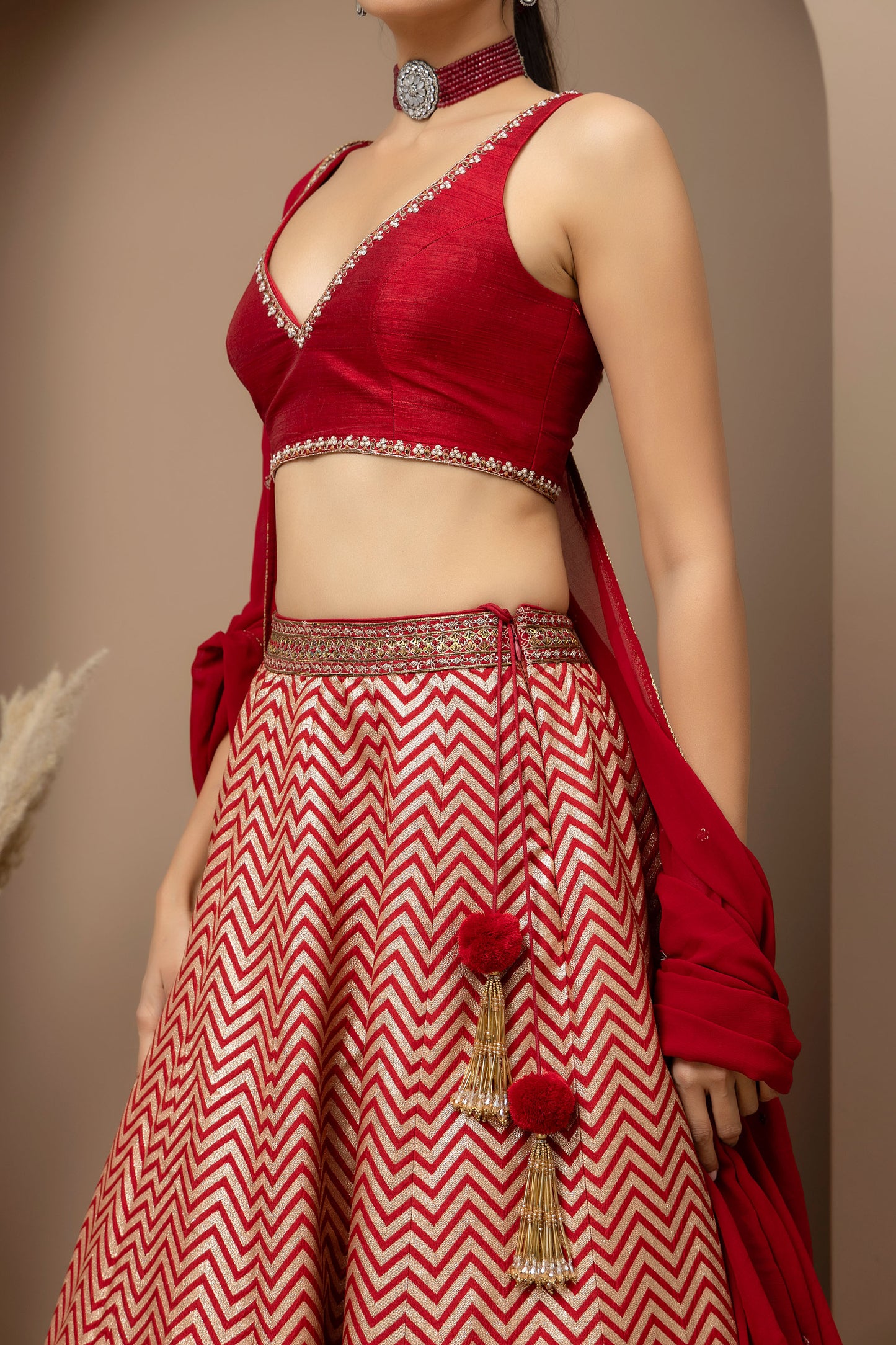 MMD/GUL/115 Silk dupion hand crafted blouse paired with chevron-patterned lehenga and a soft georgette dupatta with chinta.