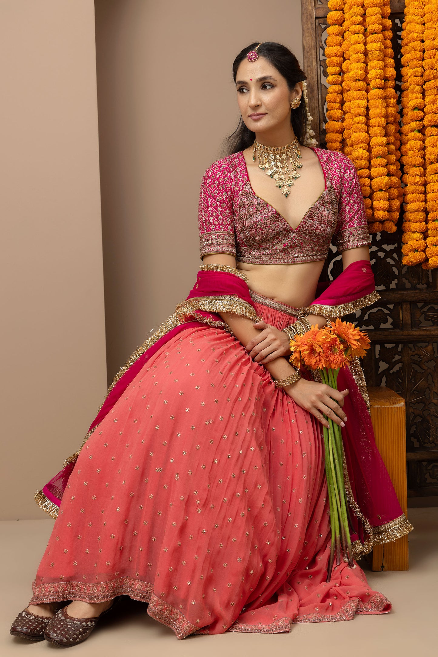 MMD/GUL/109 Gulab aangi embroidered dupion blouse with a peach georgette lehenga paired with a chinta sitara kinari dupatta.